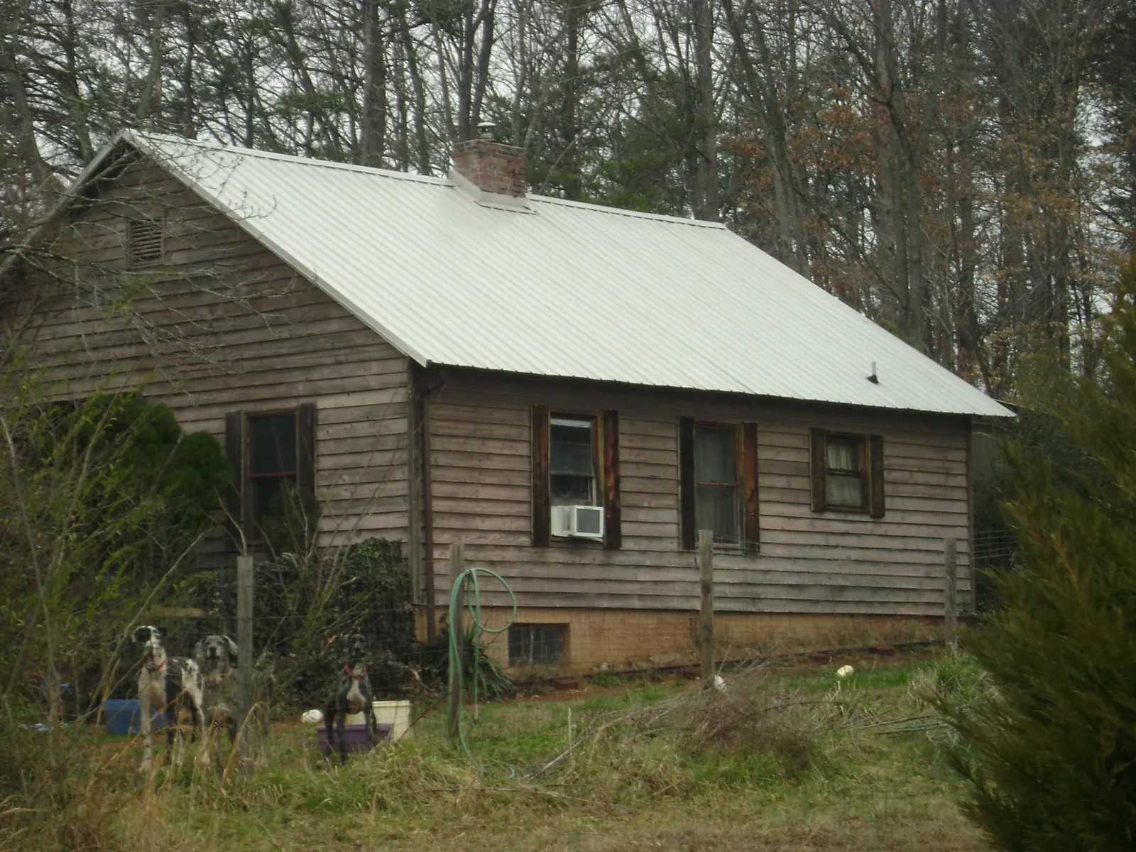 White metal roof on an old wood sided farmhouse, from a Metal Roof Installation job in Stuarts Draft